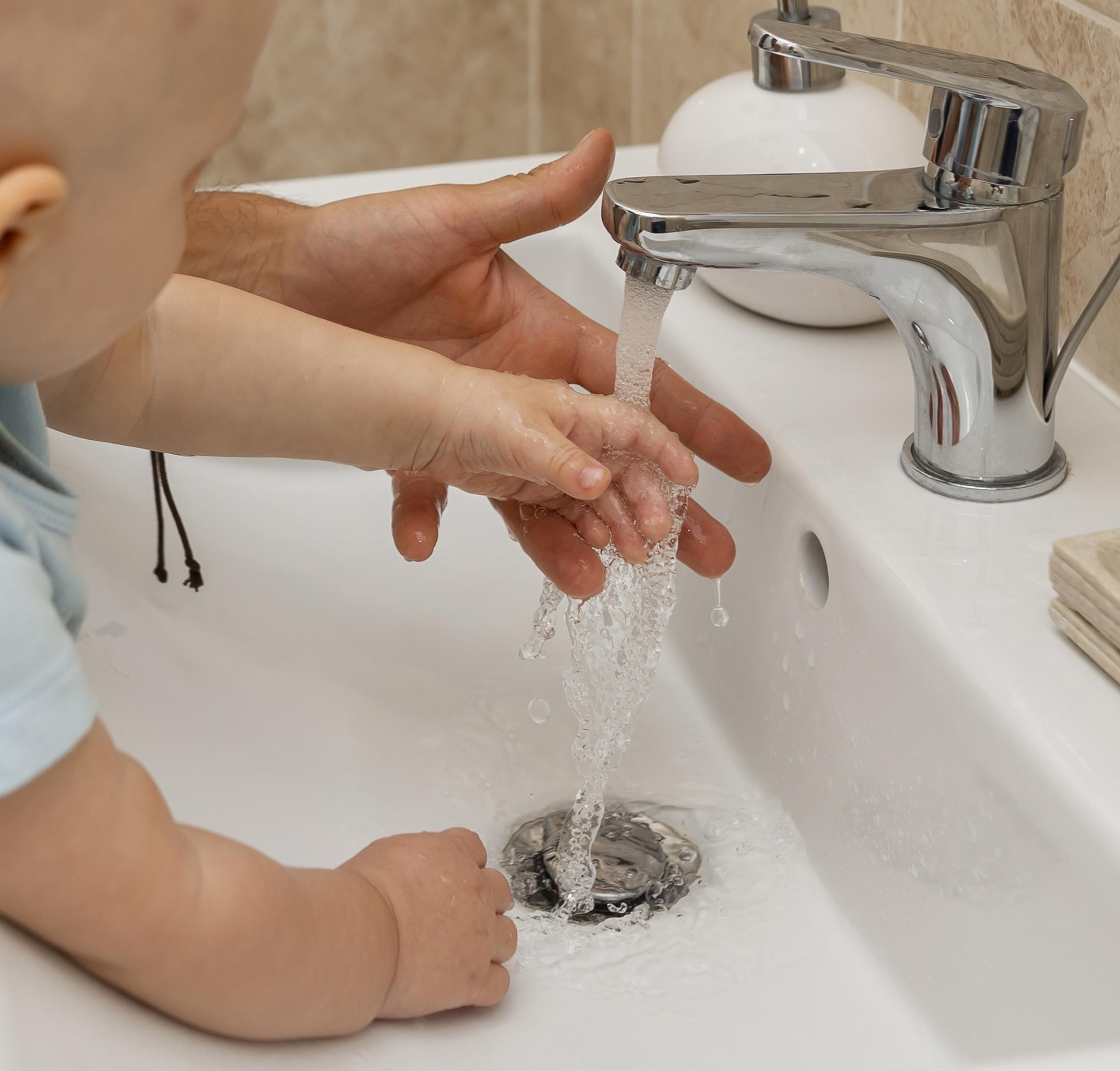 child-washing-their-hands-with-help-parents.jpg