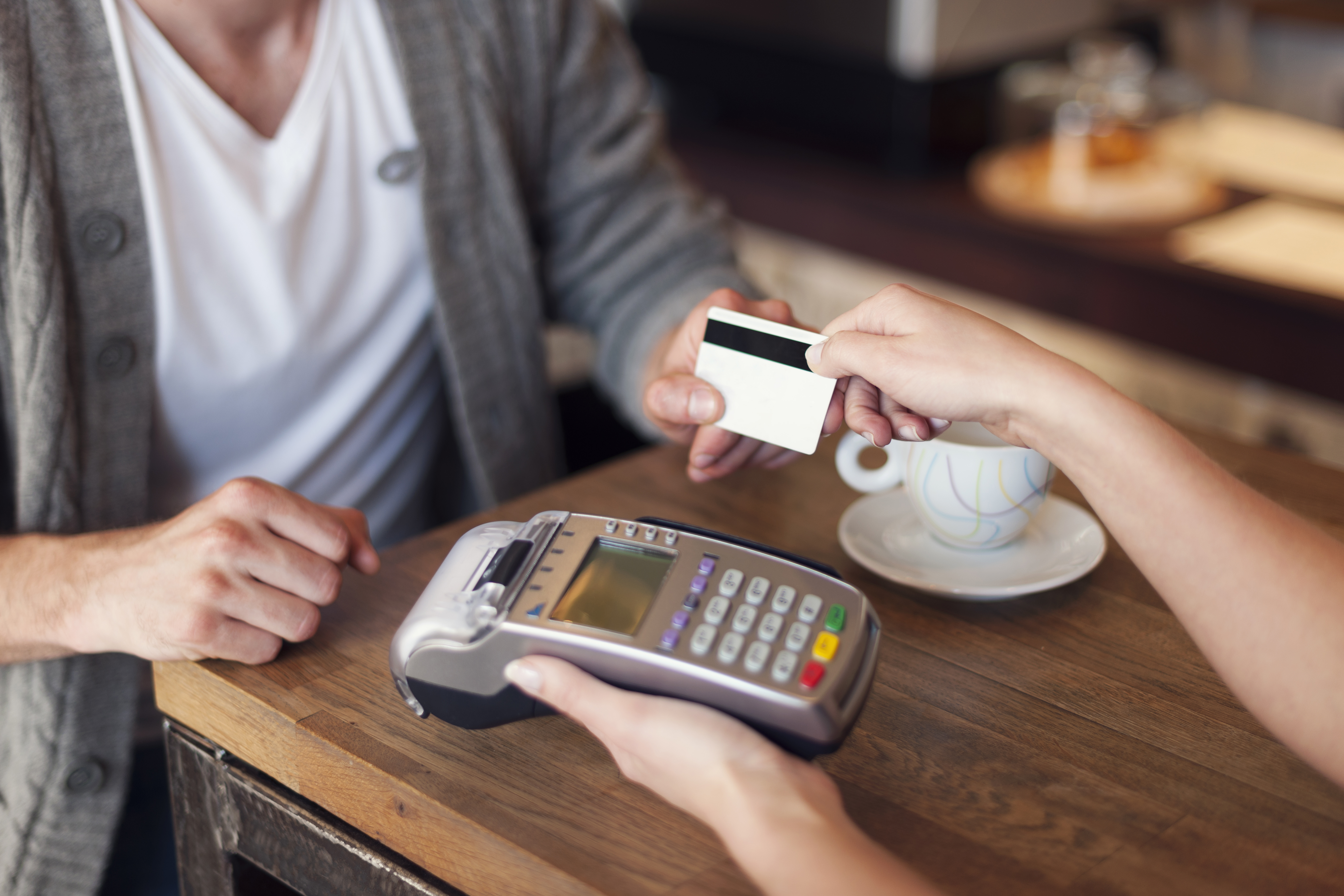 close-up-customer-paying-by-credit-card.jpg