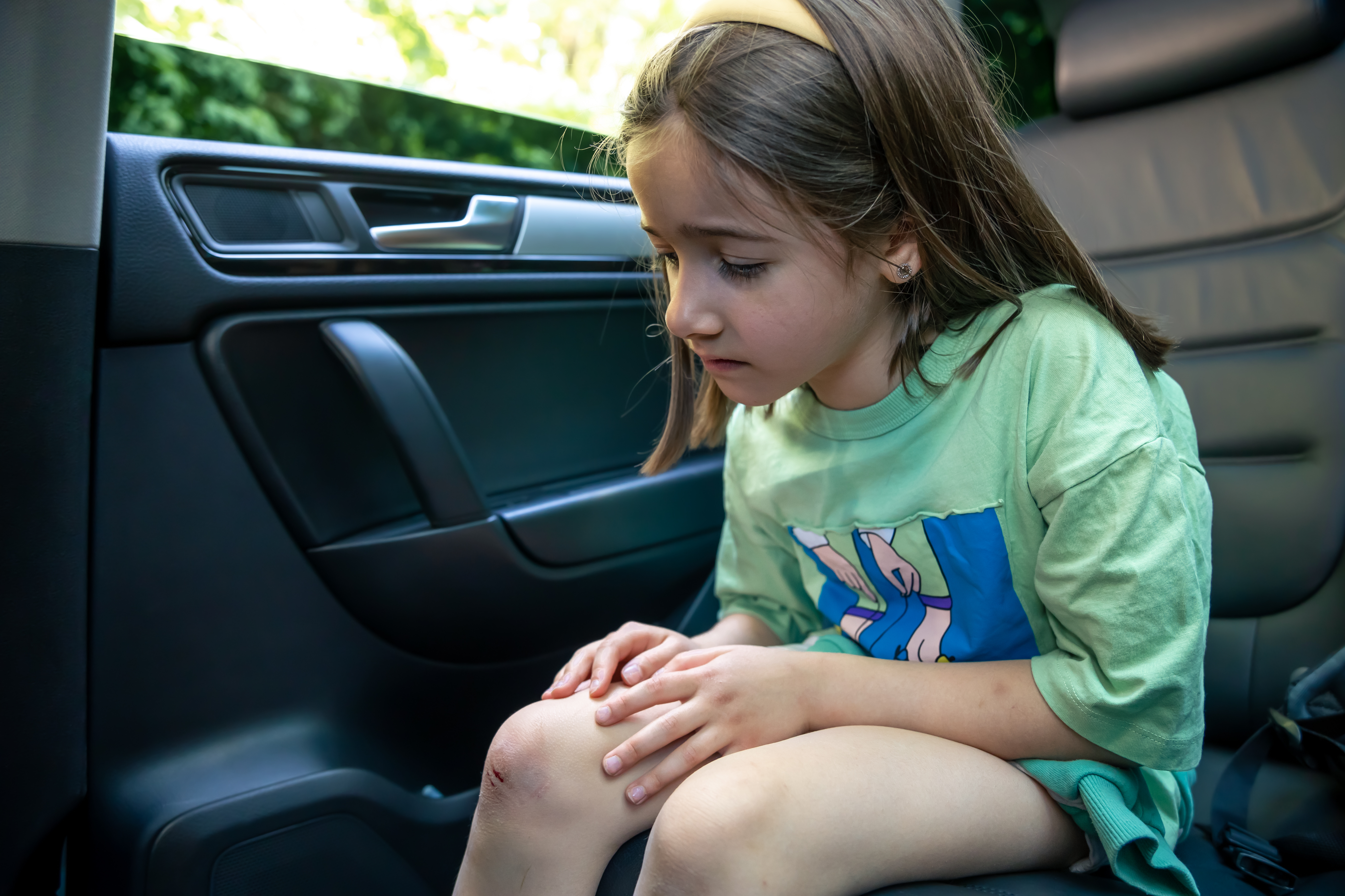closeup-little-girl-holding-her-bruised-injured-damaged-knee-with-her-hands.jpg