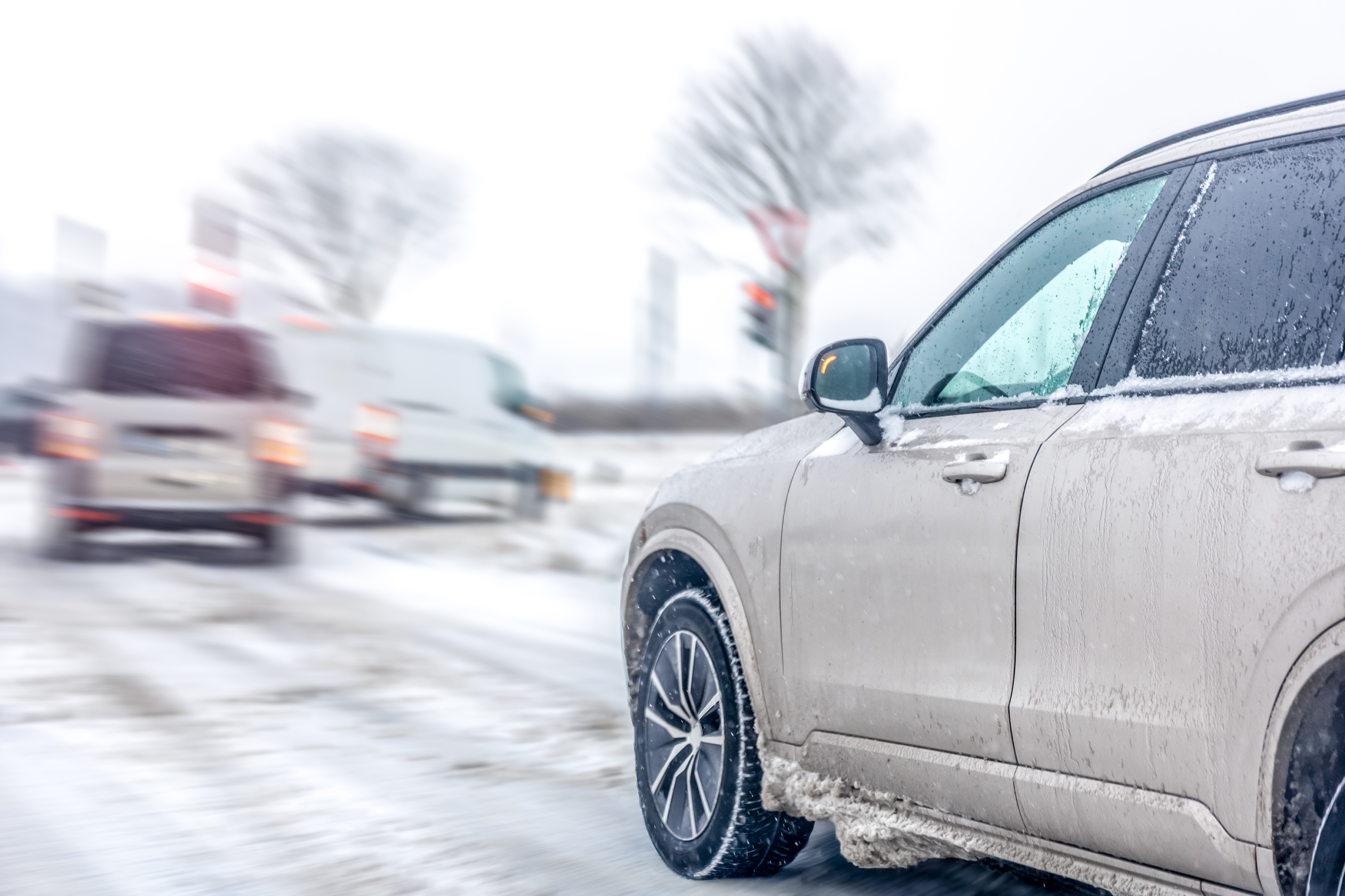 crossover-winter-slush-near-intersection-with-blurred-traffic-urban-safety.jpg
