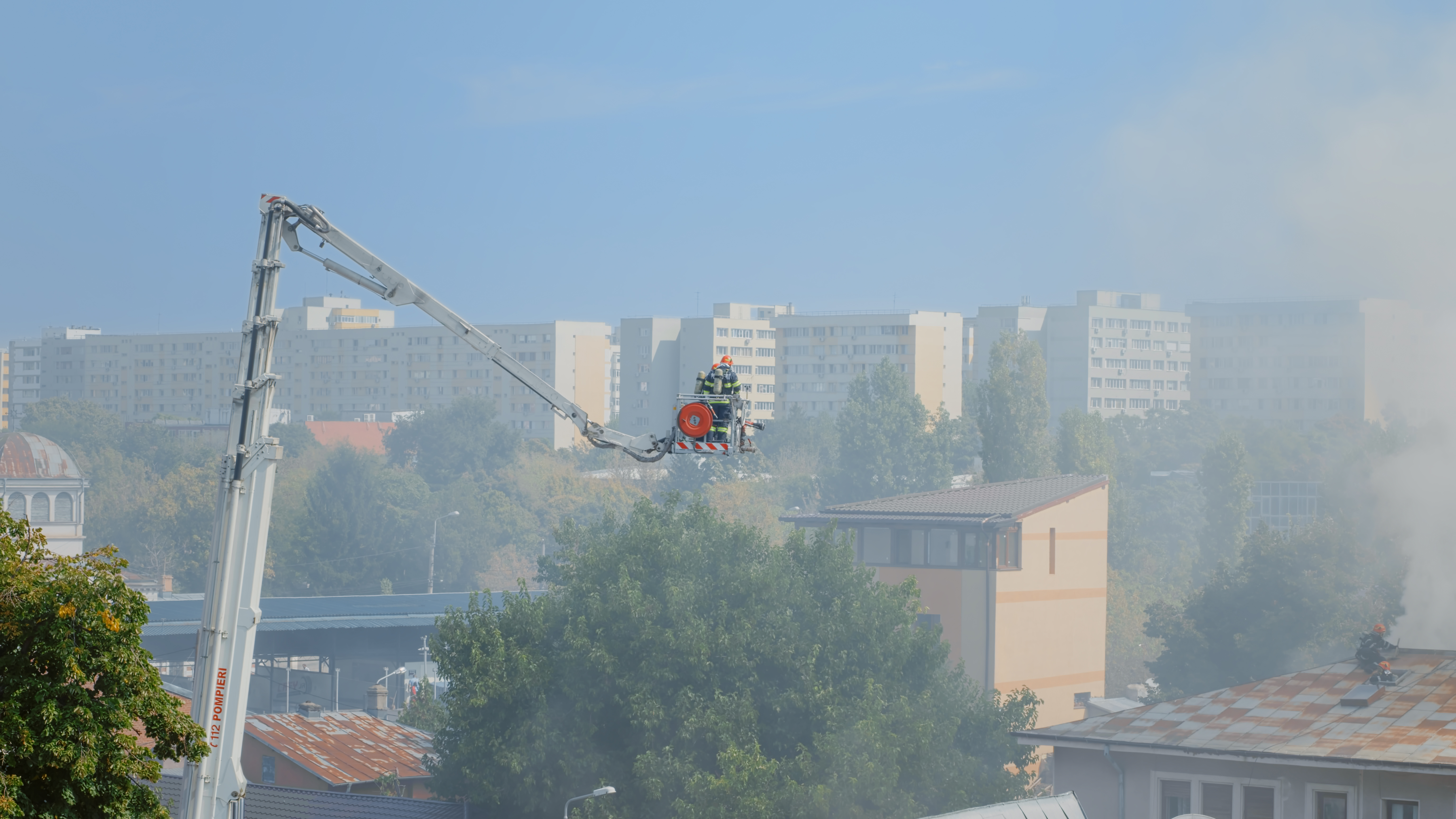firemen-platform-truck-going-roof-house-fire-view-firefighters-trying-extinguish-fire-from-burning-building-flames-fumes-men-stopping-smog-smoke-from-house.jpg