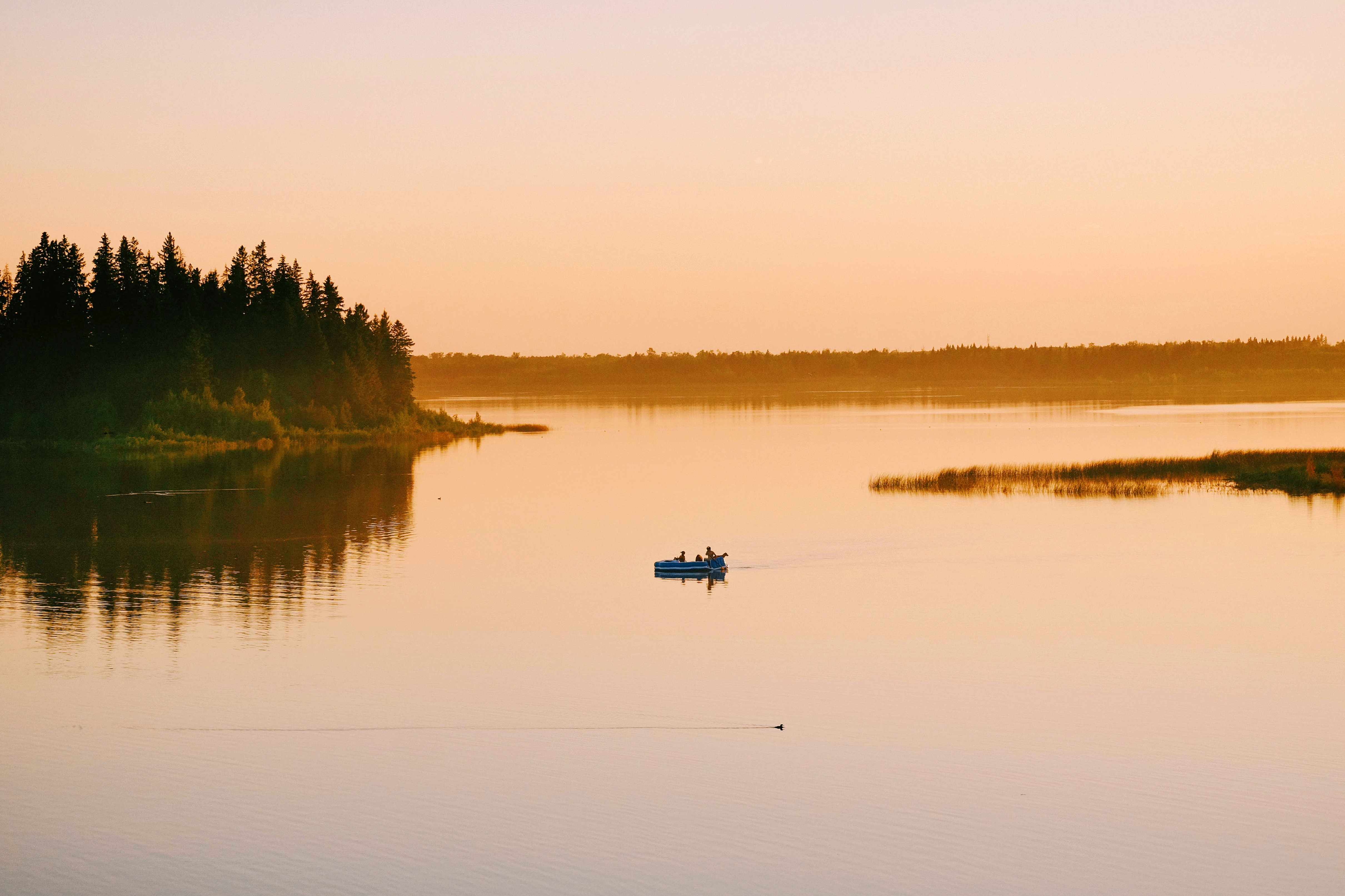 high-angle-shot-people-sailing-boat-lake-sunset.jpg