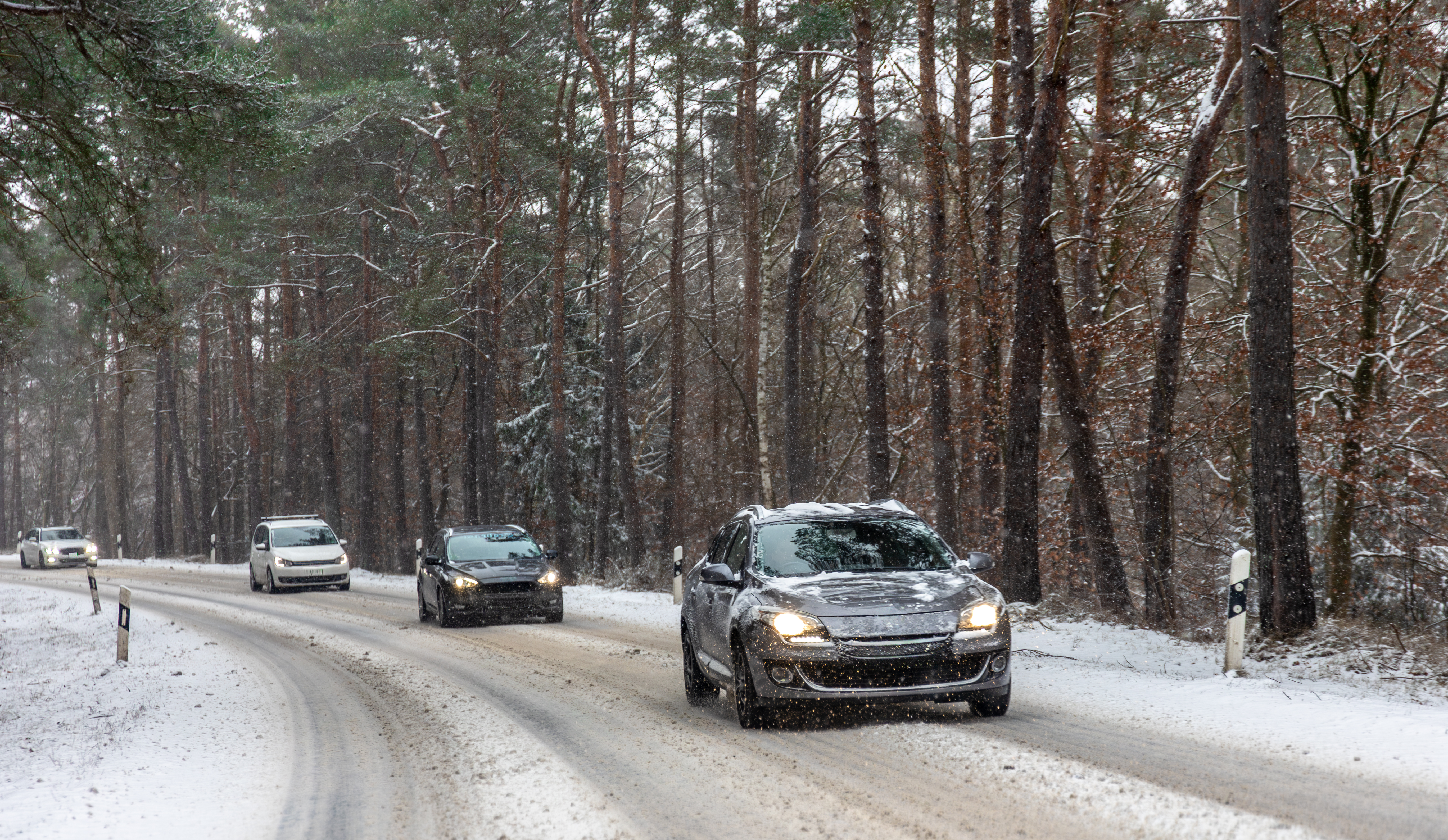 line-cars-snowy-forest-curve-winter-trip.jpg