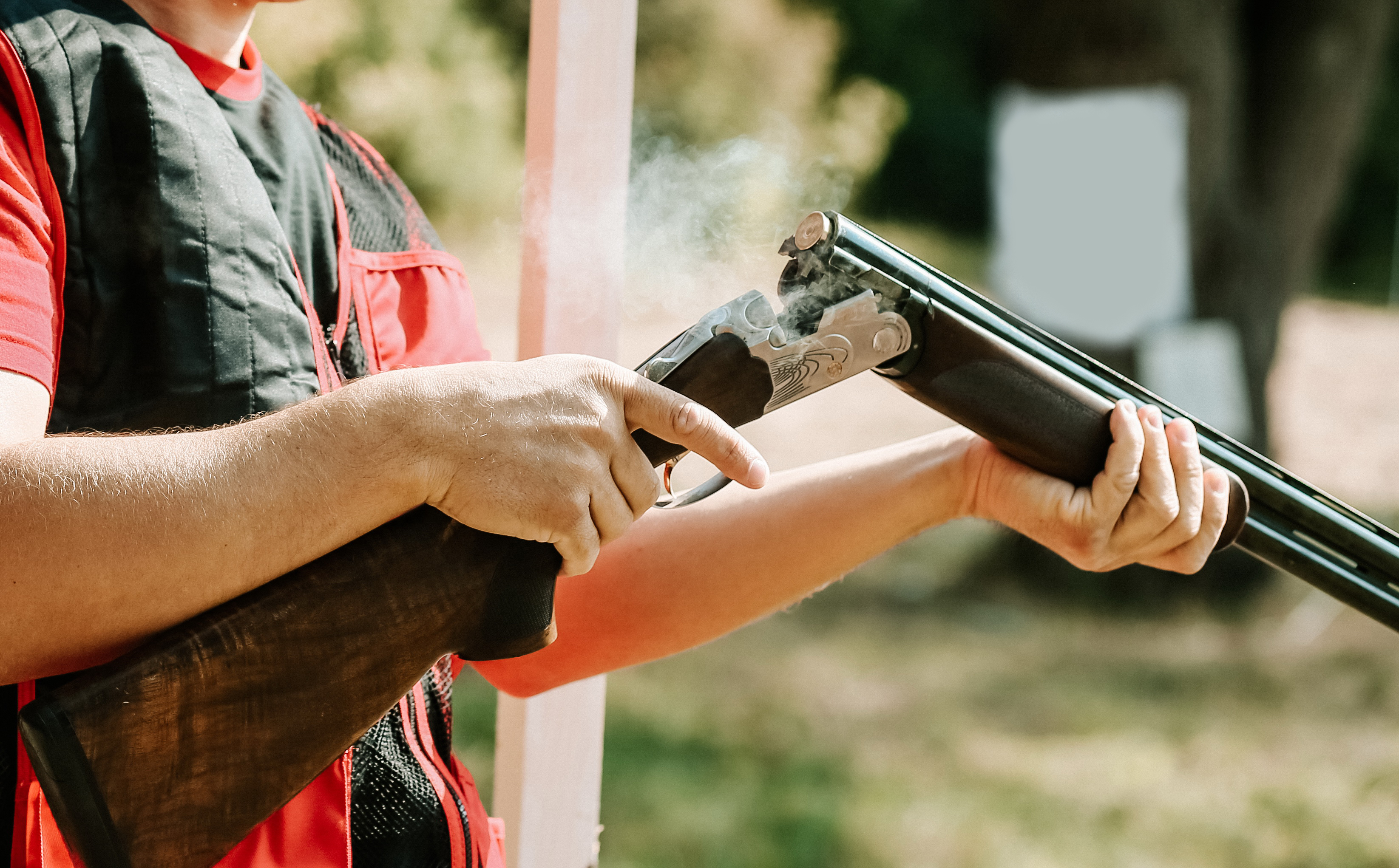 man-opens-shotgun-bolt-after-one-shot-with-smoke.jpg