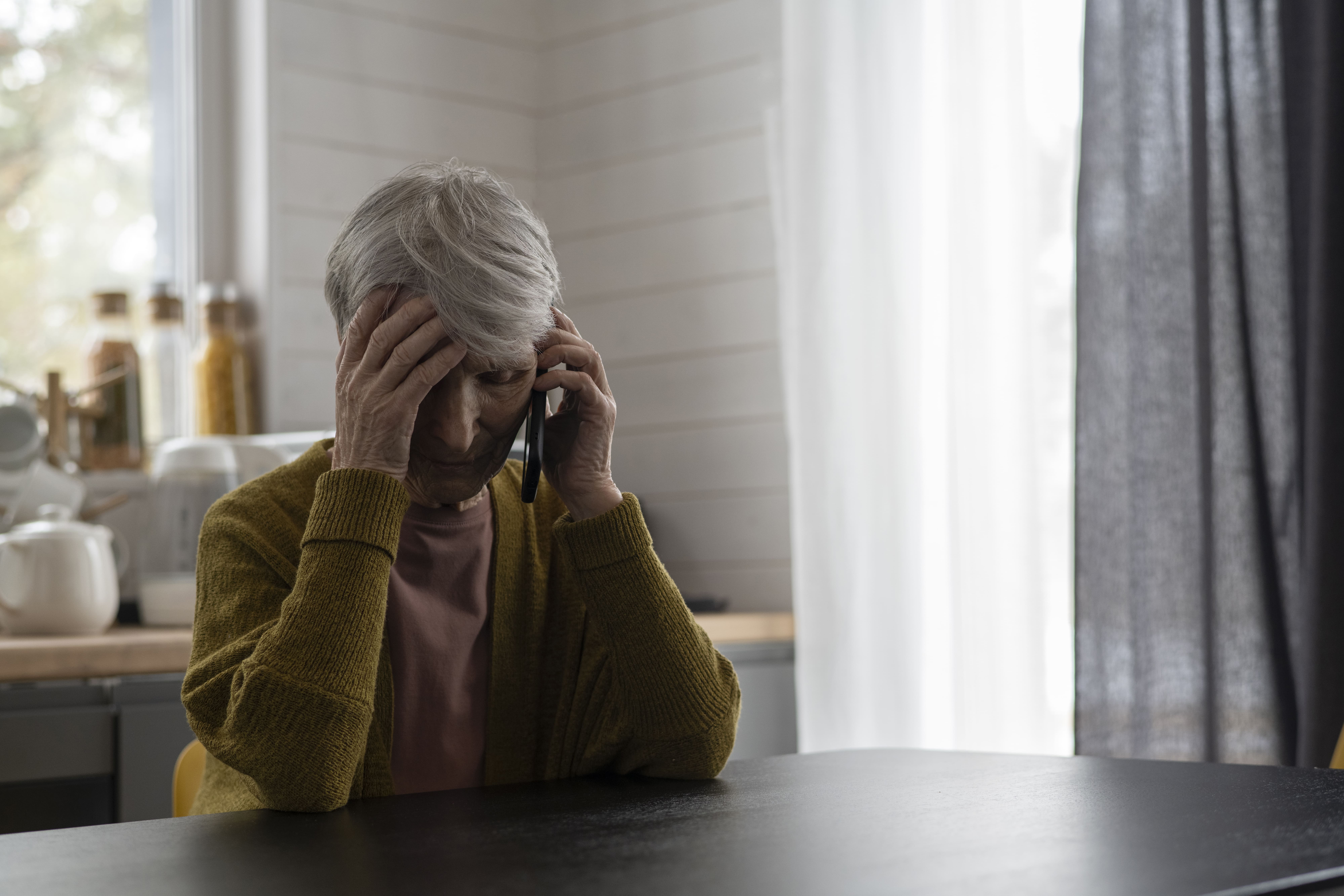 medium-shot-senior-woman-talking-phone-home-2.jpg