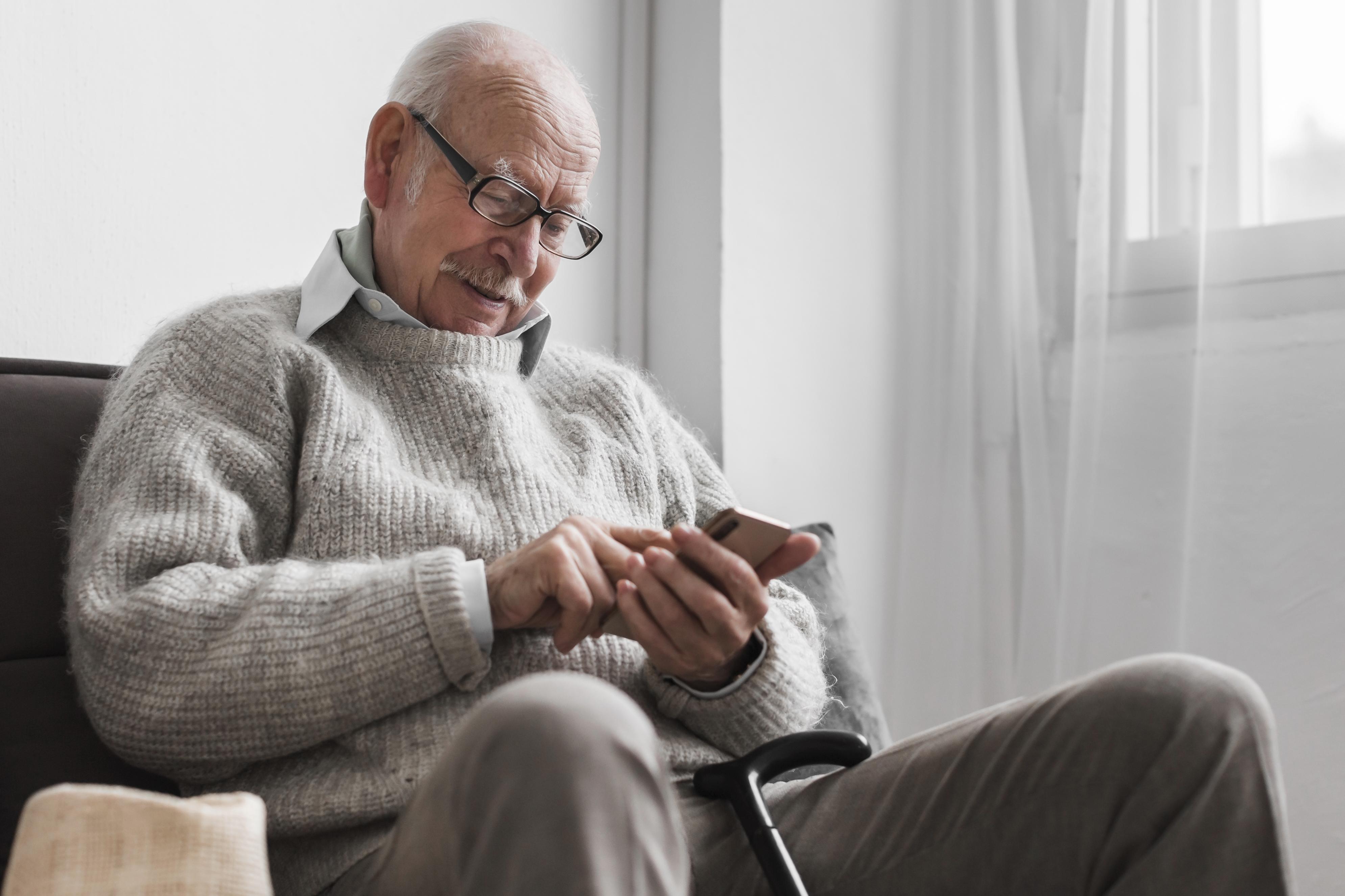 side-view-older-man-nursing-home-using-smartphone.jpg