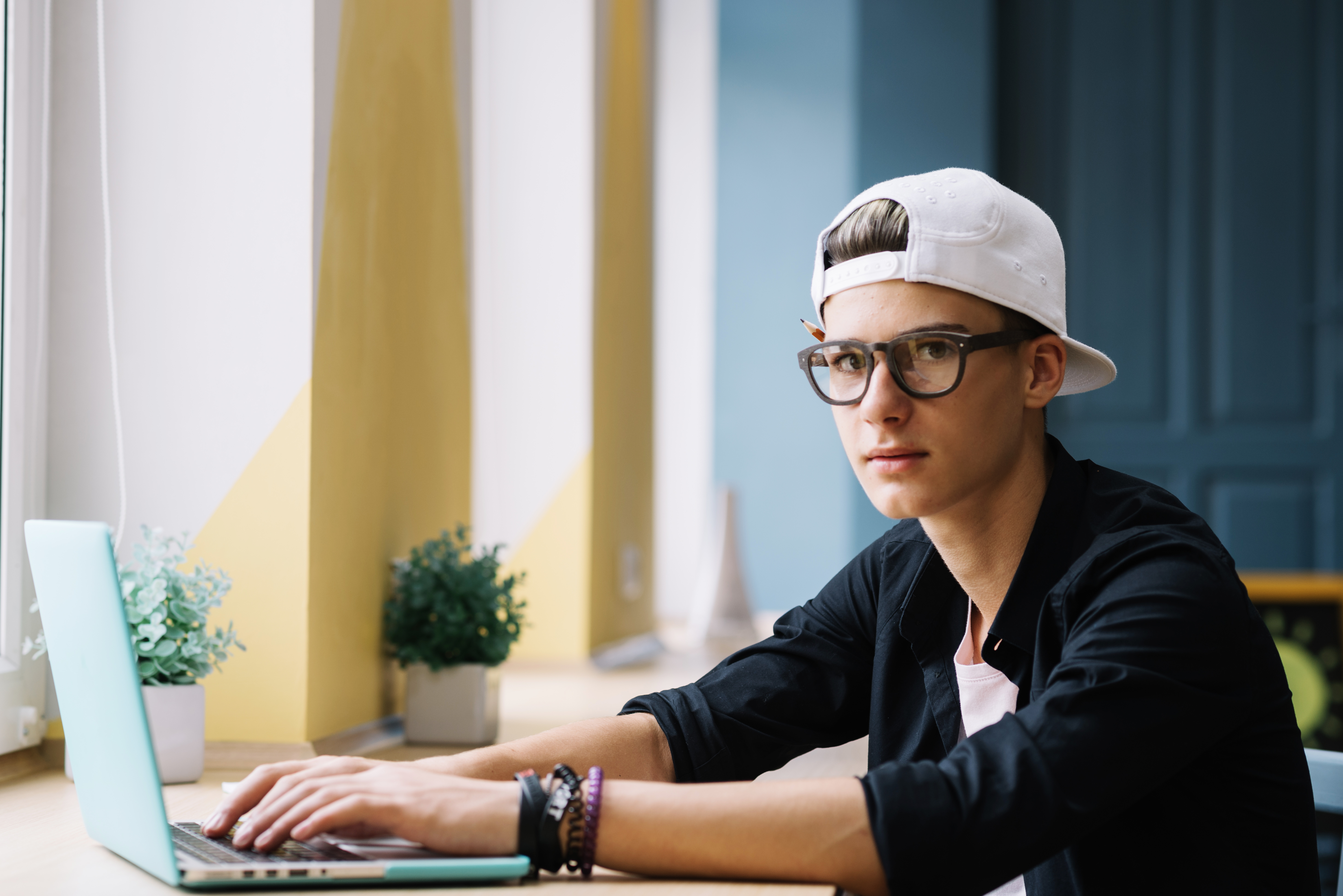 student-posing-with-laptop-classroom.jpg