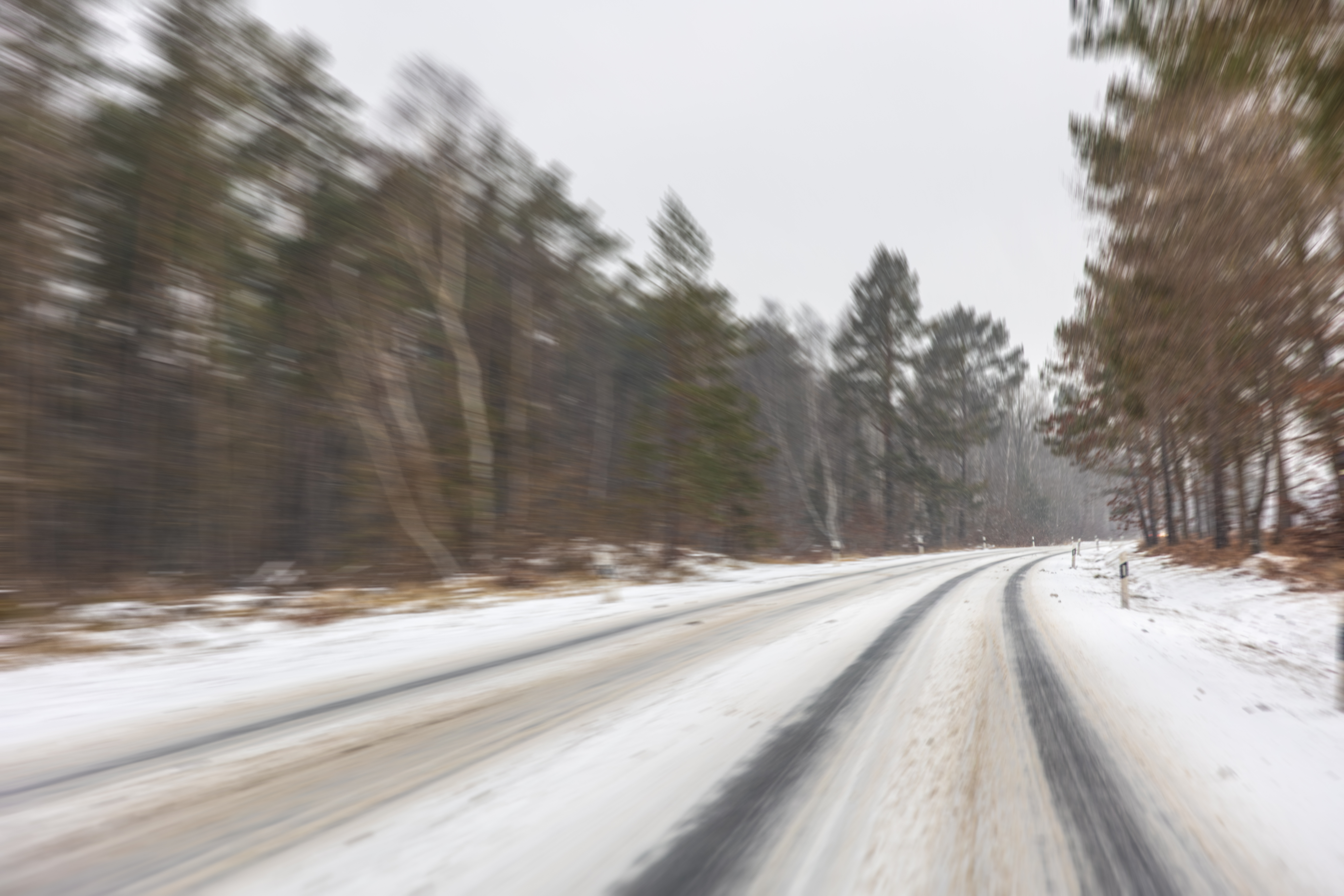 winter-road-through-forest-with-motion-blur-snowy-highway.jpg