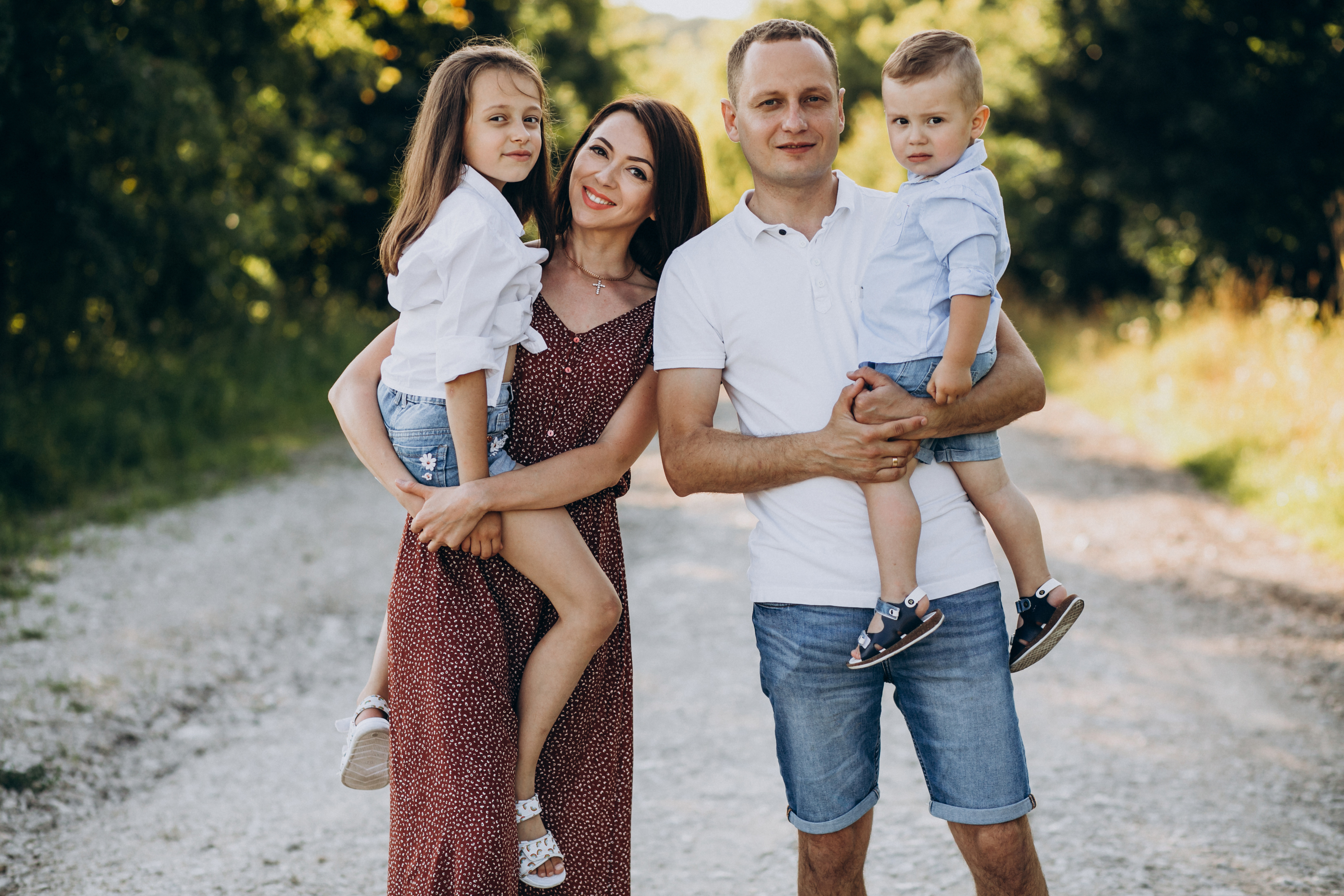 young-family-with-two-kids-walking-forest-road.jpg